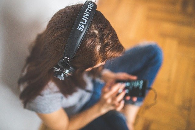 Girl practising guided morning meditation at home with headphones