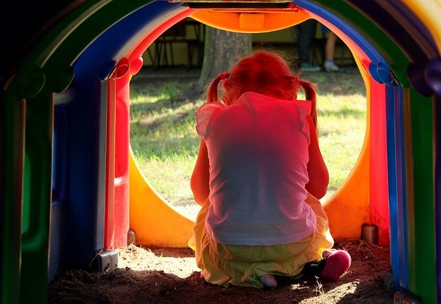 anxious child hiding at playground